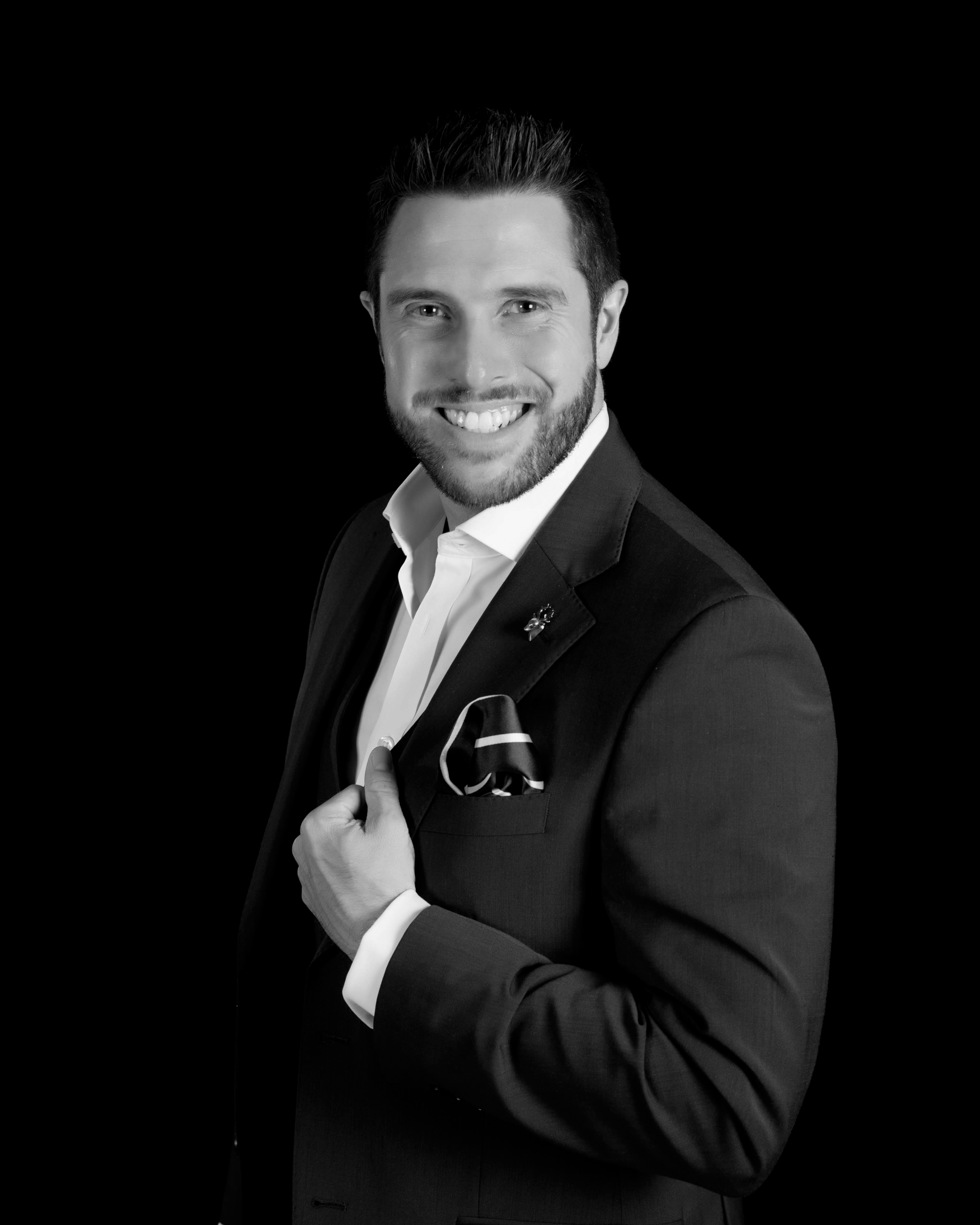 Black-and-white portrait of Alexander Percival in a suit